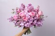 © Maksym - Elegant bouquet of pink flowers held gracefully against a soft backdrop. Generative AI