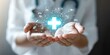 © smartcat - Hands Holding Glowing Cross Icon for Health Care Concept, Medical Aid, Insurance, Treatment, Wellness, Community Support, Innovation in Medicine