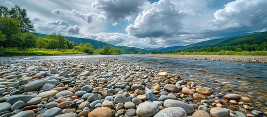 Mountain River Landscape with Stones Under Cloudy Sky