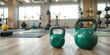 © Sarayuth - Kettlebell resting on the floor of a modern health club surrounded by yoga mats and exercise equipment, training, fitness