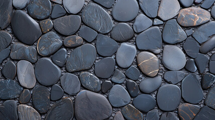 Leinwandbilder - Smooth black pebble stones create natural, textured surface in this top view image, showcasing variety of shapes and subtle color variations