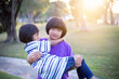 © chaunpis - Cute children play in the park at sunset.