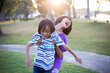 © chaunpis - Cute children play in the park at sunset.