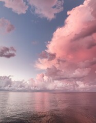 Wall Mural - Pink clouds over calm ocean water at sunset. Serene and peaceful.