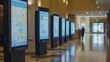 © Prostock-studio - In a contemporary hotel lobby, several digital kiosks provide interactive maps and information to visitors. The sleek design enhances the space, while a guest approaches one for assistance.