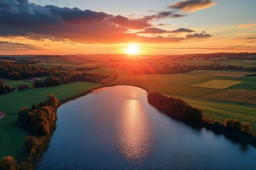 Wall Mural - Beautiful sunset over tranquil river with lush green fields