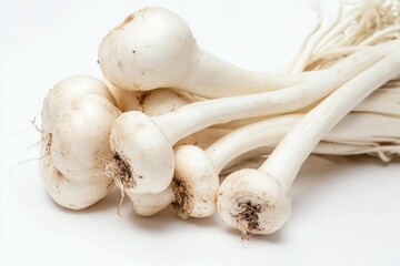 Poster - Close-up shot of a bunch of white garlic on a white surface, perfect for use in recipes or as a decorative element