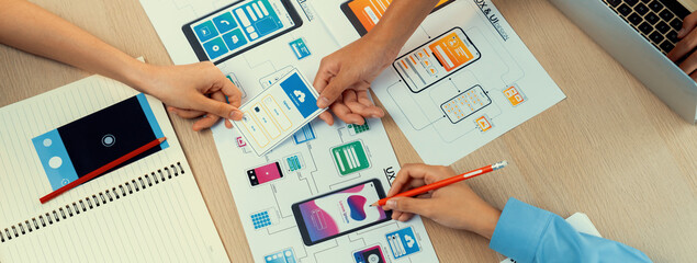 Poster - panorama banner of startup company employee planning on user interface prototype for mobile applicat