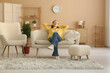 © Pixel-Shot - Young pretty woman in headphones listening music and resting on sofa in stylish living room