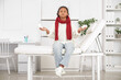 © Pixel-Shot - Ill African-American girl with tissue and pills sitting on couch in clinic