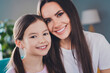 © deagreez - Portrait of positive cute daughter with mom hugging weekend time together indoors apartment room
