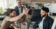 © peopleimages.com - Group, employee and high five with smile for coding, programing or software engineer system update. Celebration, creative people and happy for project management success, teamwork or data development