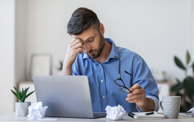 Poster - Eyes Fatigue. Overworked Businessman Tired After Long Working Day In Office, Sitting At Workplace, Massaging Nosebridge, Having Job Problems