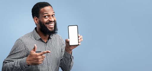 Poster - Useful App Or Website. Black man pointing at blank cell phone screen for advertising text, empty space, mock up