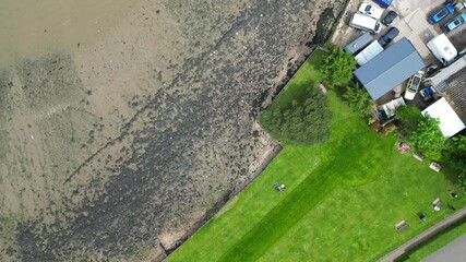 Wall Mural - High Angle View of Hythe Town on Beach and Ocean in Kent, England Great Britain. Aerial Footage of Town Homes Was Captured with Drone's Camera During Hot Weather of May 17th, 2024