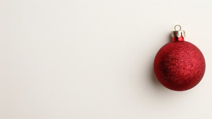Wall Mural - Red glittery Christmas ornament on a white background.