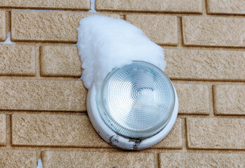 Wall Mural - A light fixture is covered in snow