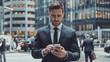 © Ozgurluk Design - Businessman Using Smartphone in Urban City Setting