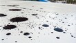 © suchetpong - Ink spots are arranged in a seemingly random manner on the clean white surface creating a unique artistic effect, spot painting, ink droplets