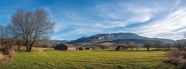 Poster - A serene landscape featuring a barn, trees, and mountains under a clear blue sky.