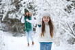 © alexkich - Young family for a walk. Mom and daughter are walking in a winter park.