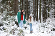 © alexkich - Young family for a walk. Mom and daughter are walking in a winter park.