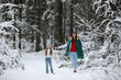 © alexkich - Young family for a walk. Mom and daughter are walking in a winter park.