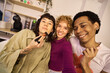 © alvaro - Multiethnic friends applying makeup together at home