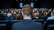 © Roman - Audience Watching a Presentation in a Modern Auditorium During an Evening Event
