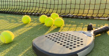 Wall Mural - Background of padel racket and ball on artificial grass floor in outdoor court. Top view.