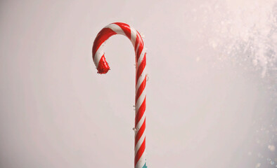 Poster - Red and white cane with a red stripe. The cane is leaning on a wall