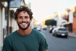 © Odin AI - The image captures a bearded man wearing a green shirt, smiling broadly on a busy urban street, conveying positivity and an easygoing nature.