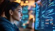 © setiadio - A woman focused on coding at a computer screen displaying lines of programming.
