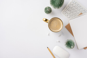 A top view of a winter-themed workspace featuring a coffee cup, keyboard, notebook, and decorative plants. Ideal for creative professionals and winter office inspiration