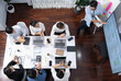 © InfiniteFlow - Top view analyst team utilizing BI Fintech to analyze financial data at table in meeting room. Analytic BI dashboard power on paper for business insight and strategic marketing planning. Prudent