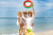 © MrPanya - Happy family having fun on summer vacation with floaties on the beach.