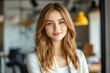 © Nognapas - Close-up headshot Confident European young woman, good looking teenager, middle aged leader, businesswoman, CEO on blurred office background. Beautiful young European businesswoman smiles at thecamera