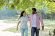 © Photographielove - Joyful Walk: A Couple Enjoying a Peaceful Moment Together,A candid photograph of a happy couple walking arm in arm through a lush green park.