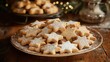 © Nany - A plate of freshly baked Christmas cookies shaped like stars, trees, and snowflakes, dusted with powdered sugar