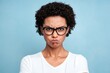 © Zaleman - This angry angry woman has an afro hairstyle, clenches her teeth out of anger, stares with hatred, frowns, wears sunglasses and casual white clothes, models on blue background, and expresses hateful