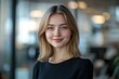 © Nognapas - Close-up headshot Confident European young woman, good looking teenager, middle aged leader, businesswoman, CEO on blurred office background. Beautiful young European businesswoman smiles at thecamera