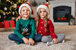 © New Africa - Cute little kids with Santa hats in room decorated for Christmas