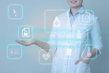 Medical privacy. Health worker using virtual screen with different icons, closeup. Lock symbol over hand