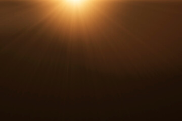 Wall Mural - orange spotlight effect or crepuscular rays isolated on black background