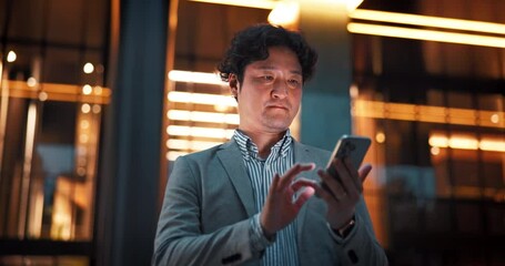 Poster - City, phone and Asian man at night for business communication, typing email and social media. Professional, corporate and Japanese worker on smartphone for transport service, contact and networking