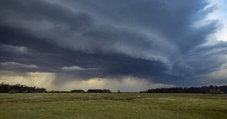 stormy sky with dark clouds and a large, rolling thundercloud