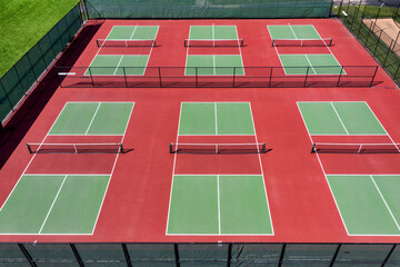 Aerial view of pickleball facility with red and green courts