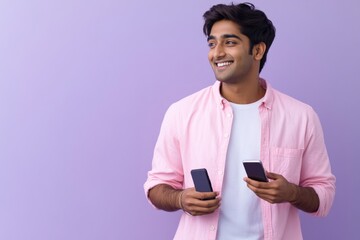 Poster - A person holding two mobile devices, possibly for comparison or multitasking