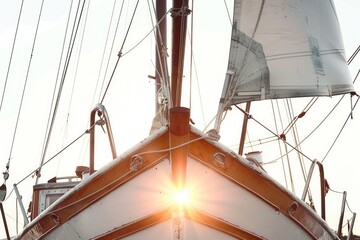 Wall Mural - A sailboat with sunlight shining through its sails