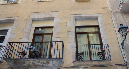 Wall Mural - The table and chairs are on the balconies in the house. The street lamp hangs on the wall.